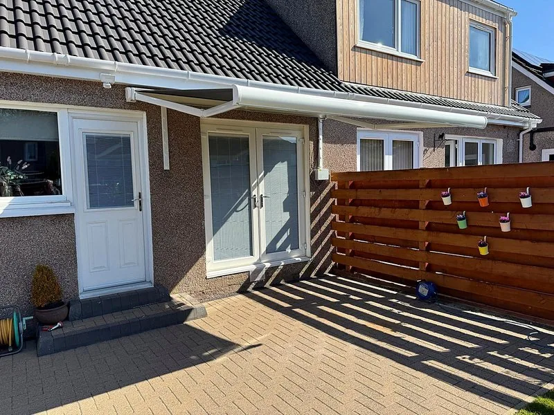 Retractable awning extending over an outdoor seating area