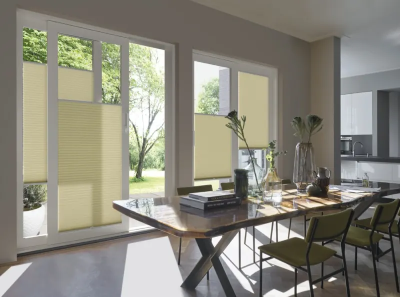 Green Duette blinds on bifold doors in a dining room