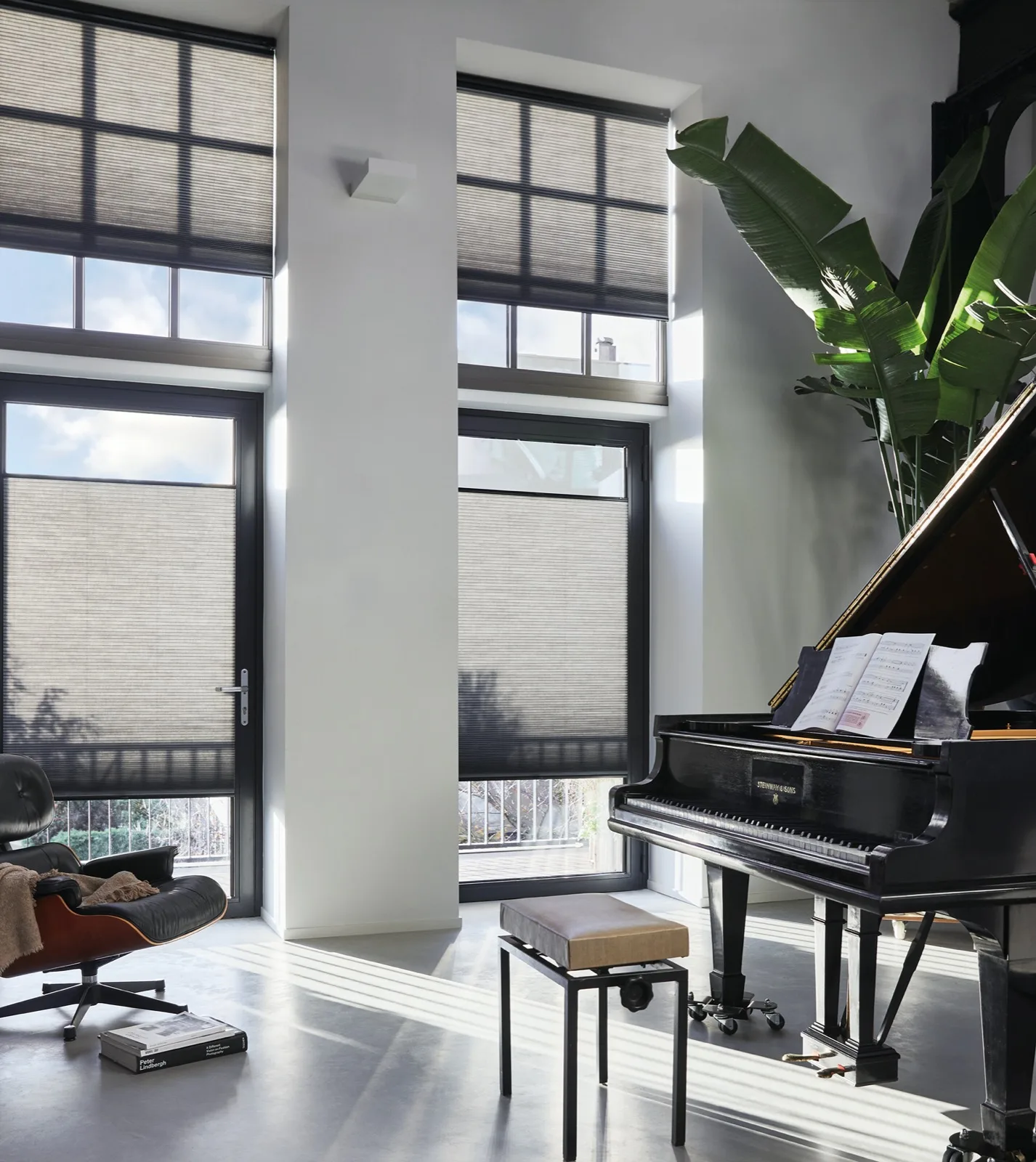 TruFit Duette blinds clipped to tall window frames beside a grand piano