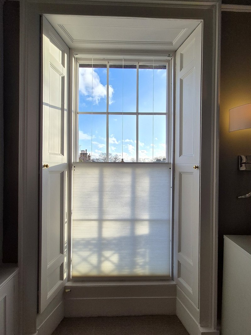 Duette blind on a sash window with blue sky