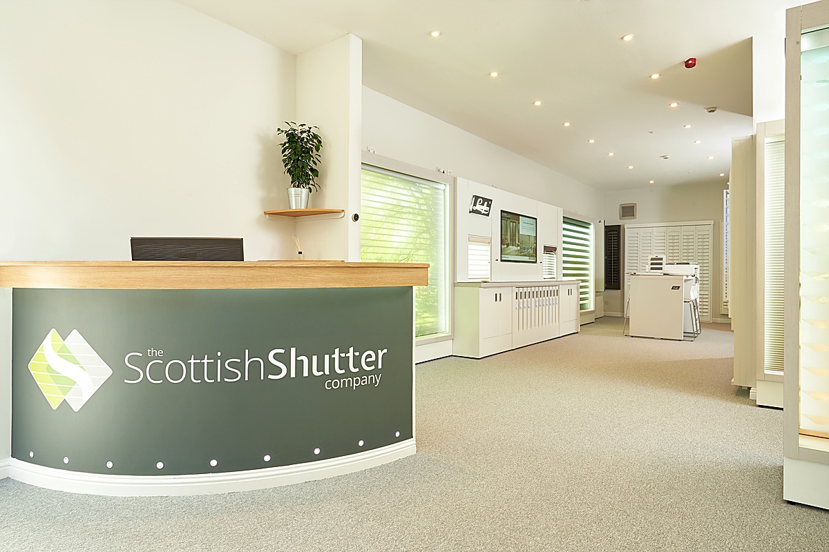 Reception area at The Scottish Shutter Company Edinburgh Design Studio with branded desk and product displays