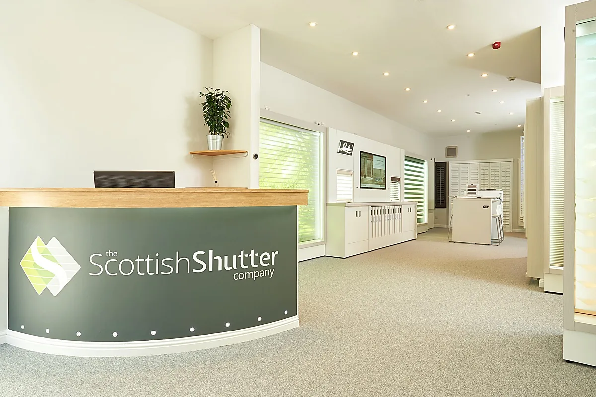 Reception area at The Scottish Shutter Company Edinburgh Design Studio with branded desk and product displays