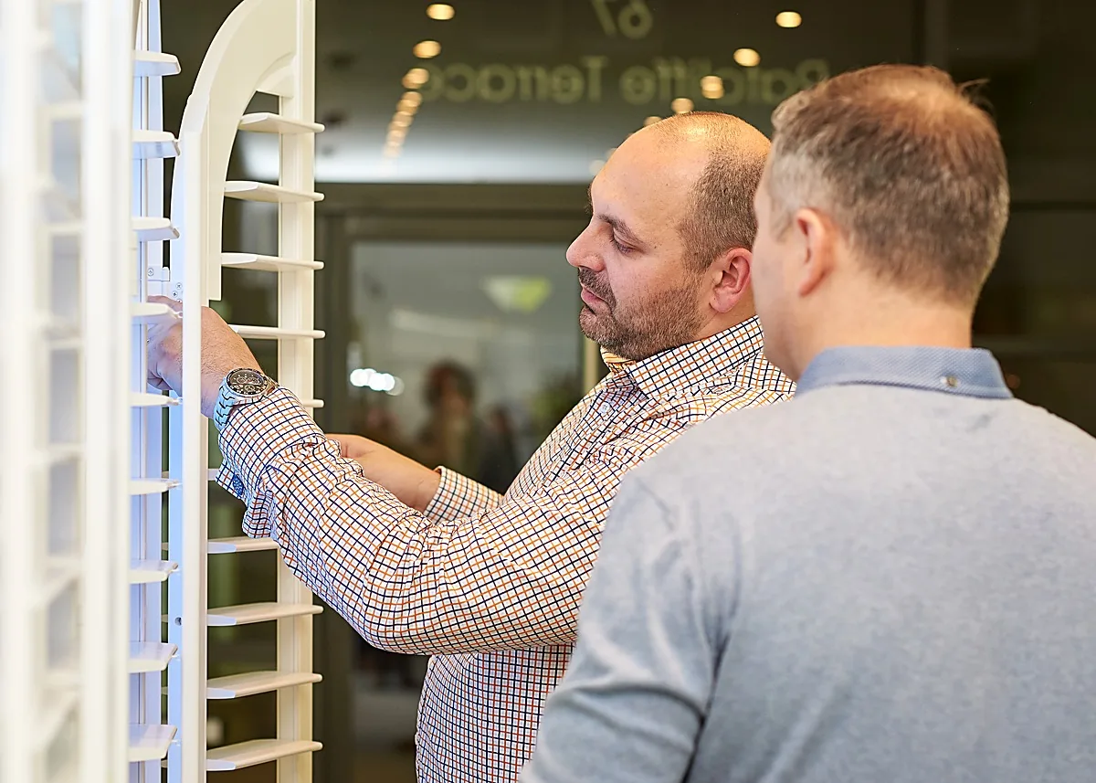 A visitor trying full size working shutters at the Edinburgh Design Studio open evening