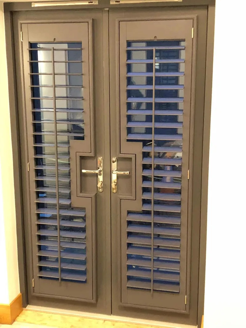 An image of french doors with custom shutters added