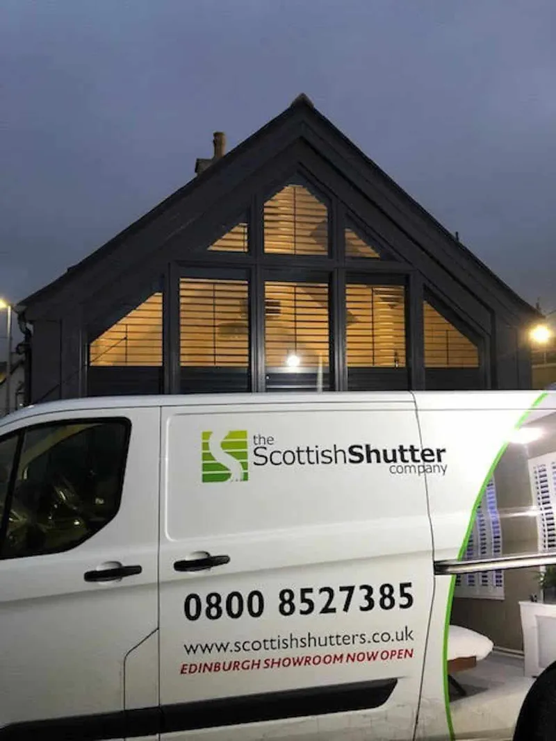 outside view in the evening of the trapezoidal gable and a white van in-front branded "Scottish Shutter Company'