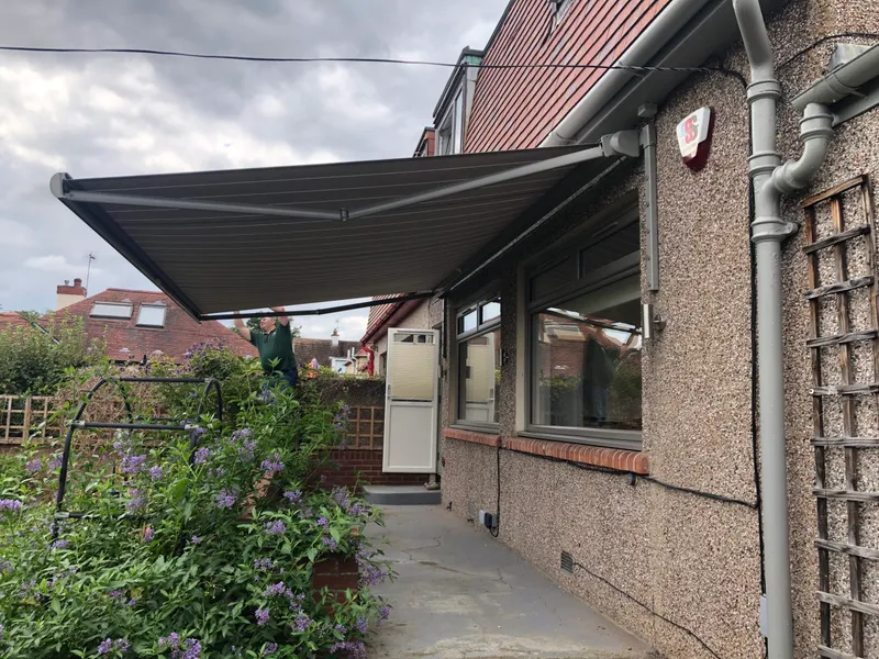 Motorised awning over outdoor dining area