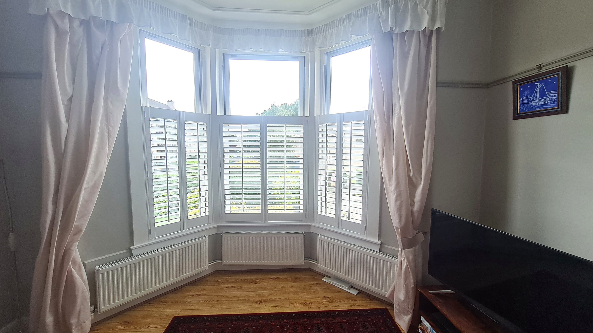 Cafe style shutters on bay windows