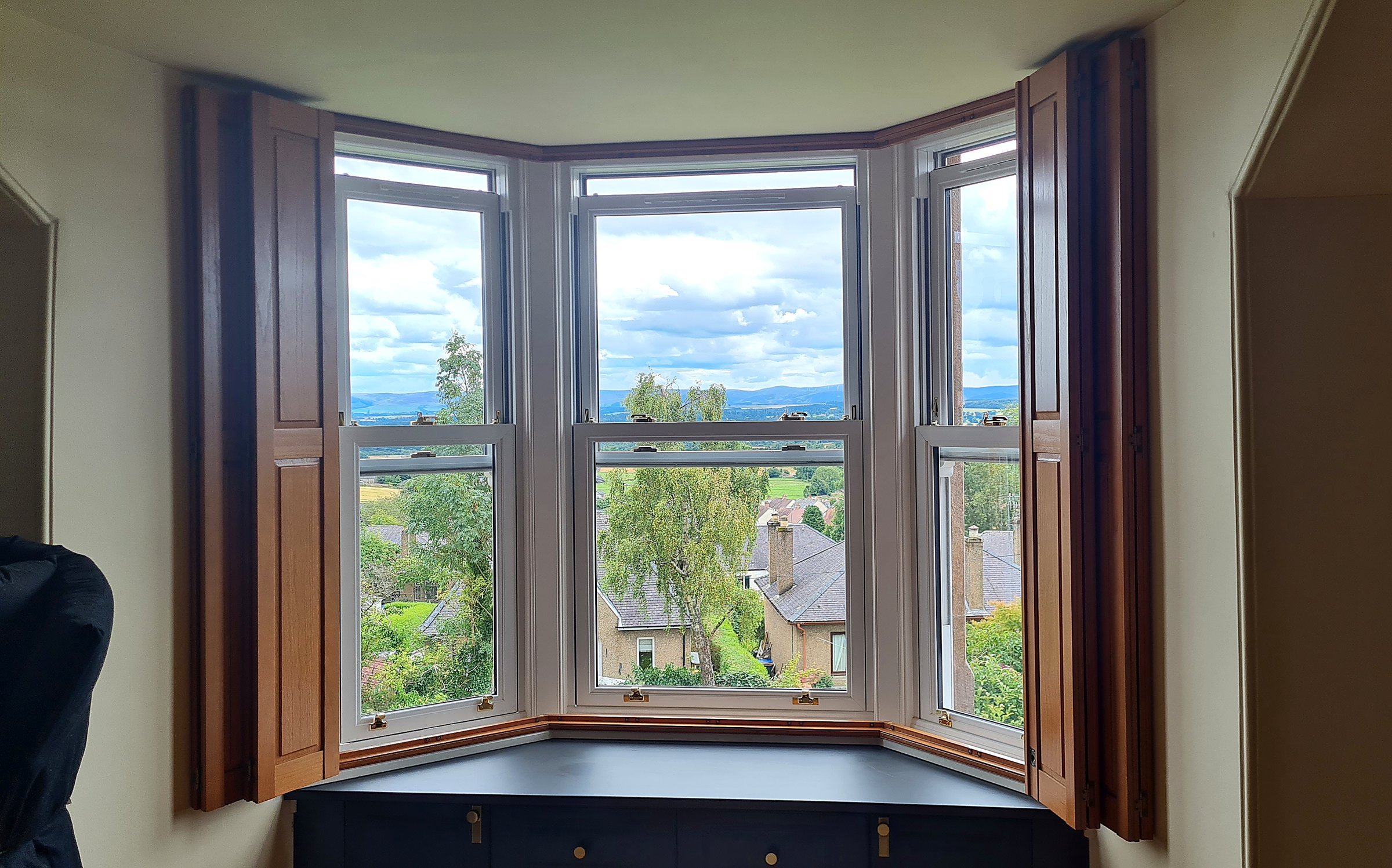 Solid panel shutters on bay windows