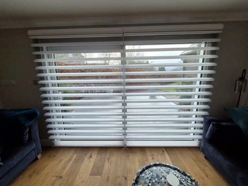 White Pirouette blinds on large patio doors in a modern living room
