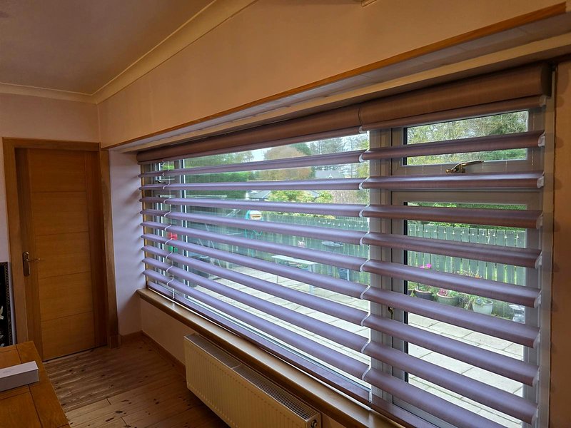 Pirouette blinds with tilted vanes on a wide window