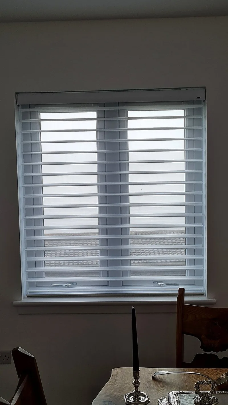 White Silhouette blinds with horizontal vanes above a dining table