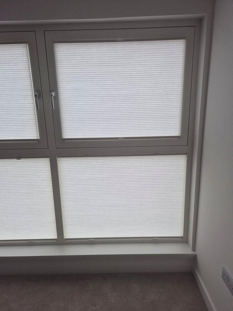 White TruFit blinds clipped to grey window frames