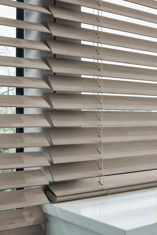 Painted wood venetian blind in a bright room